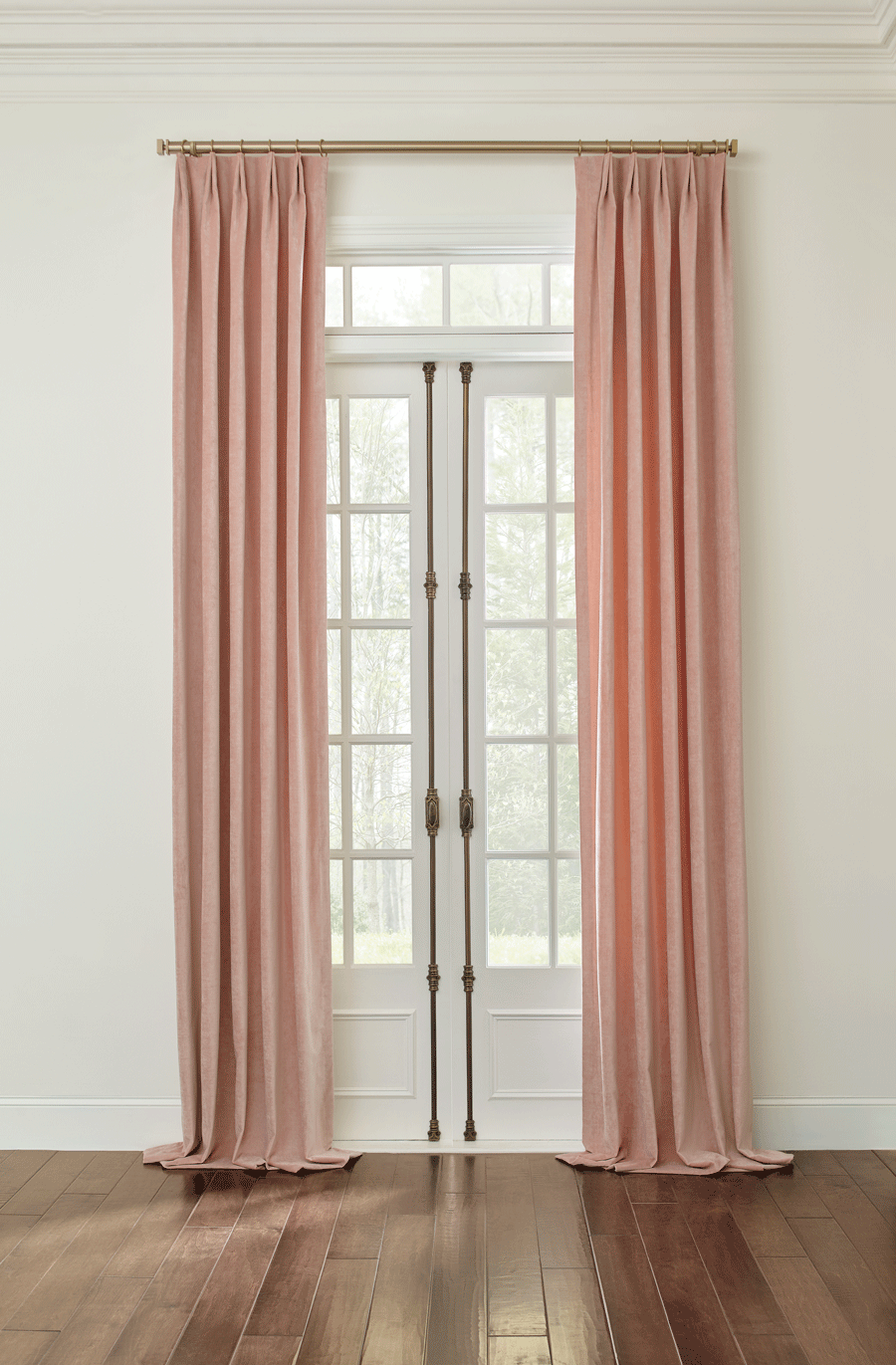 Drapery panels puddled on the floor create a layer window treatments look.