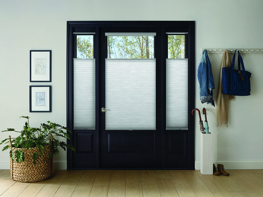 A front door with Applause® Legends™ Honeycomb Shades with LiteRise®.