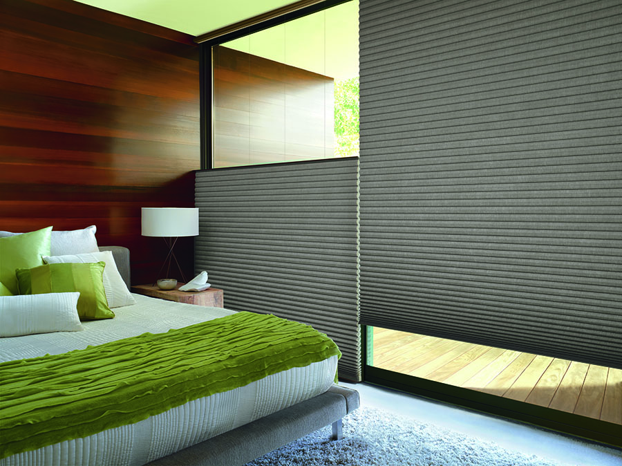 A bed room with Alustra® Duette® Architella® Macon™ honeycomb shades with UltraGlide®.