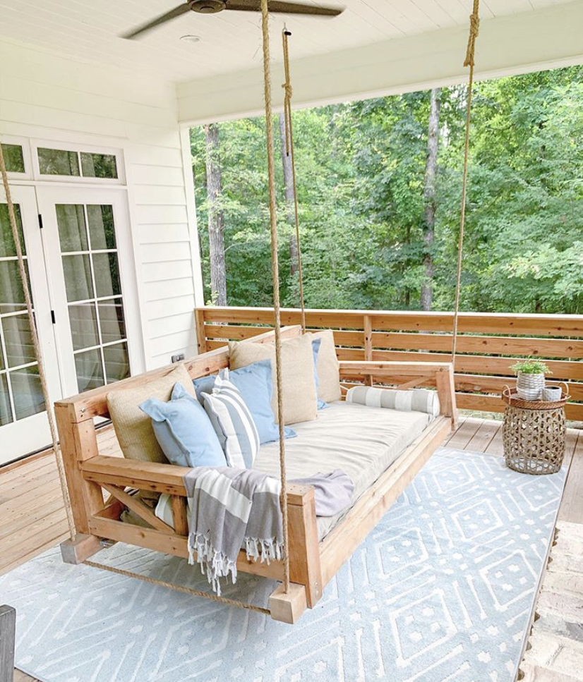 Montgo Farmhouse patio swing features one of the current design trends: woods.