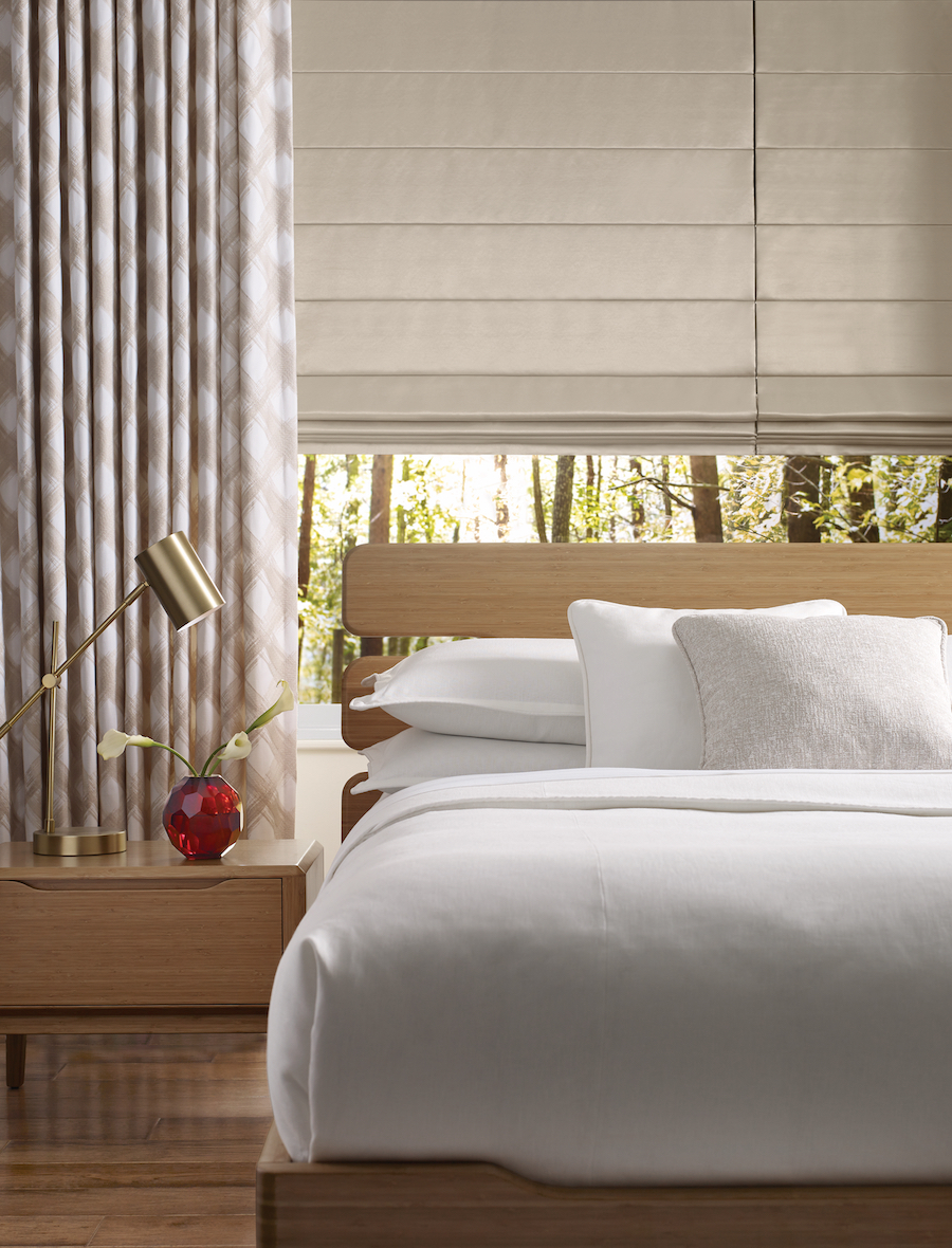 Bedroom with brown roman shades.