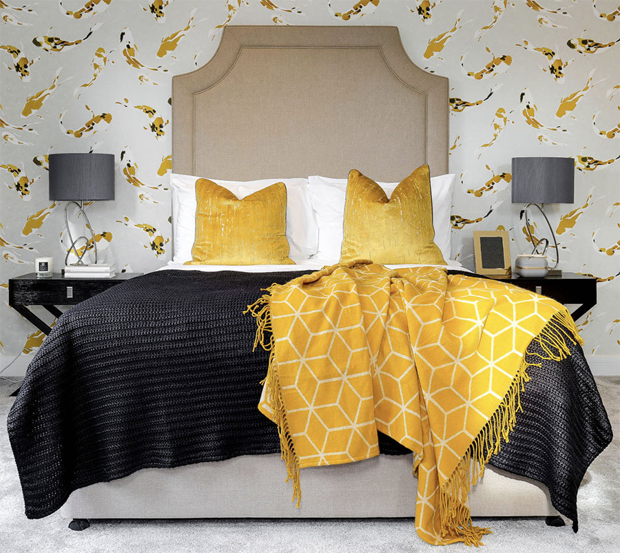 Bedroom with yellow accents and wallpaper.