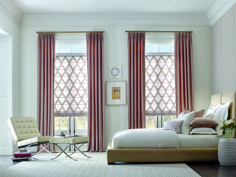 Pink drapes paired with gold hardware in bedroom.