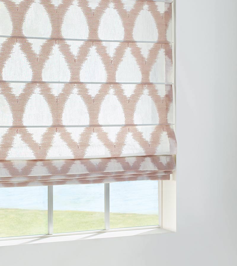 detail of white and pink ikat pattern roman shade