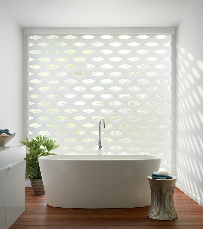 coastal inspired bathroom with large tub and white window shadings