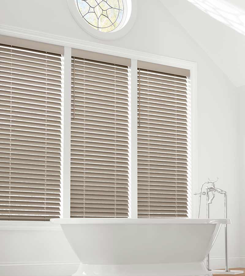 medium wood faux wood blinds in bathroom in Olathe KS