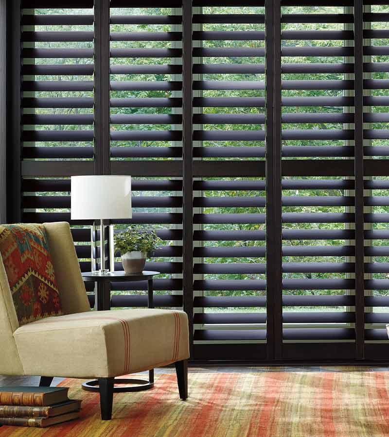 floor to ceiling living room window with wood shutters in Lee’s Summit 64086