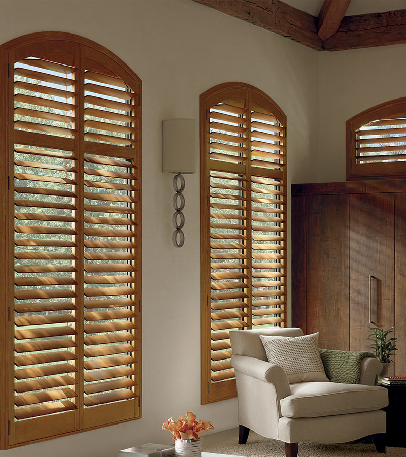 traditional brown shutters as arched window treatments in Overland Park KS home