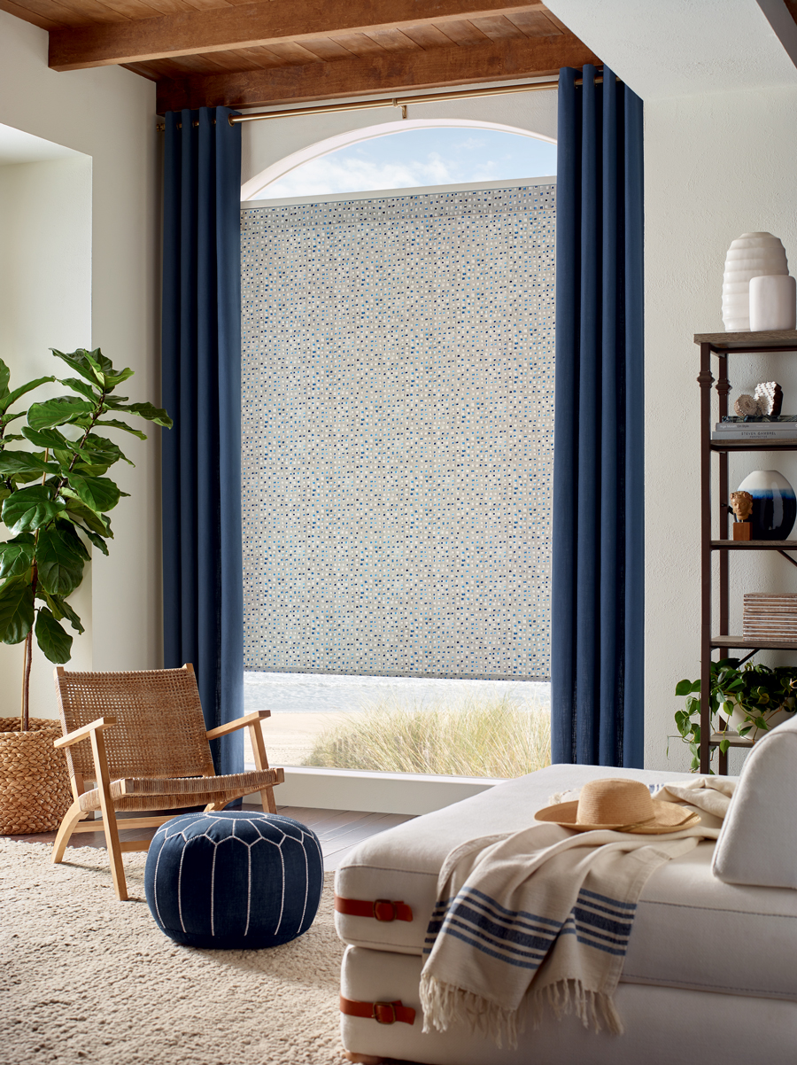 floor to ceiling blue drapery and patterned screen shades over arched window in Shawnee, KS