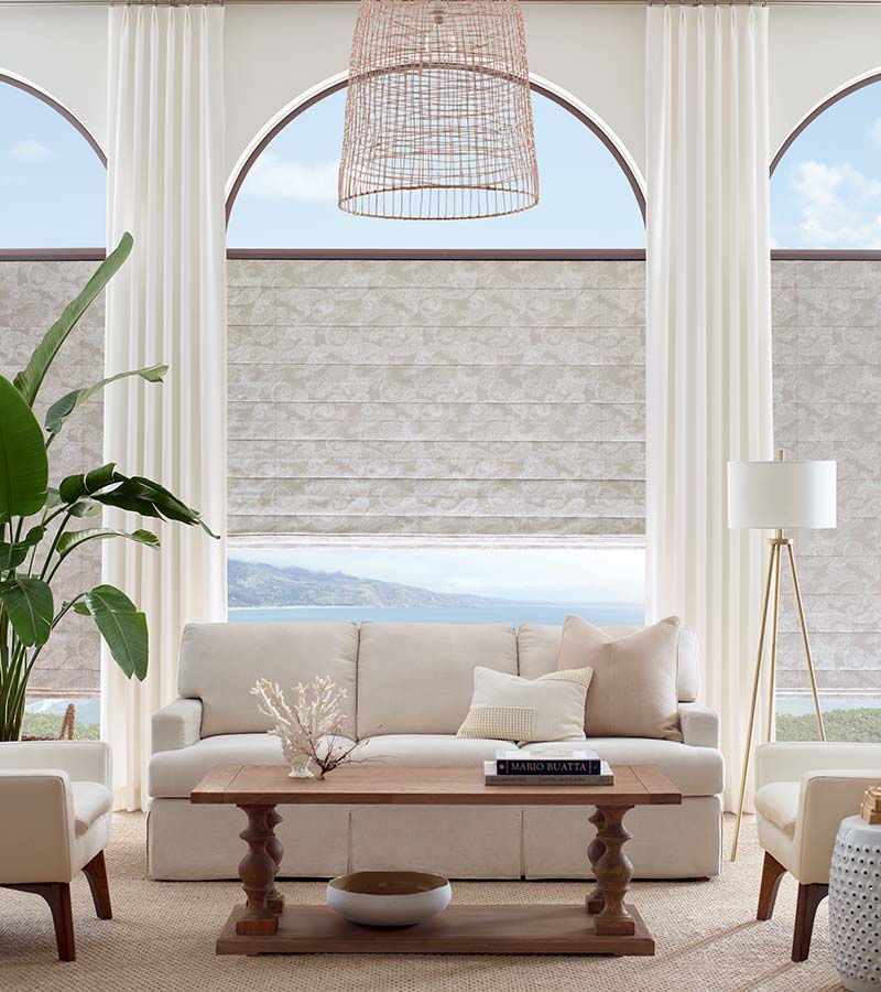 floor to ceiling arched windows in modern neutral living room