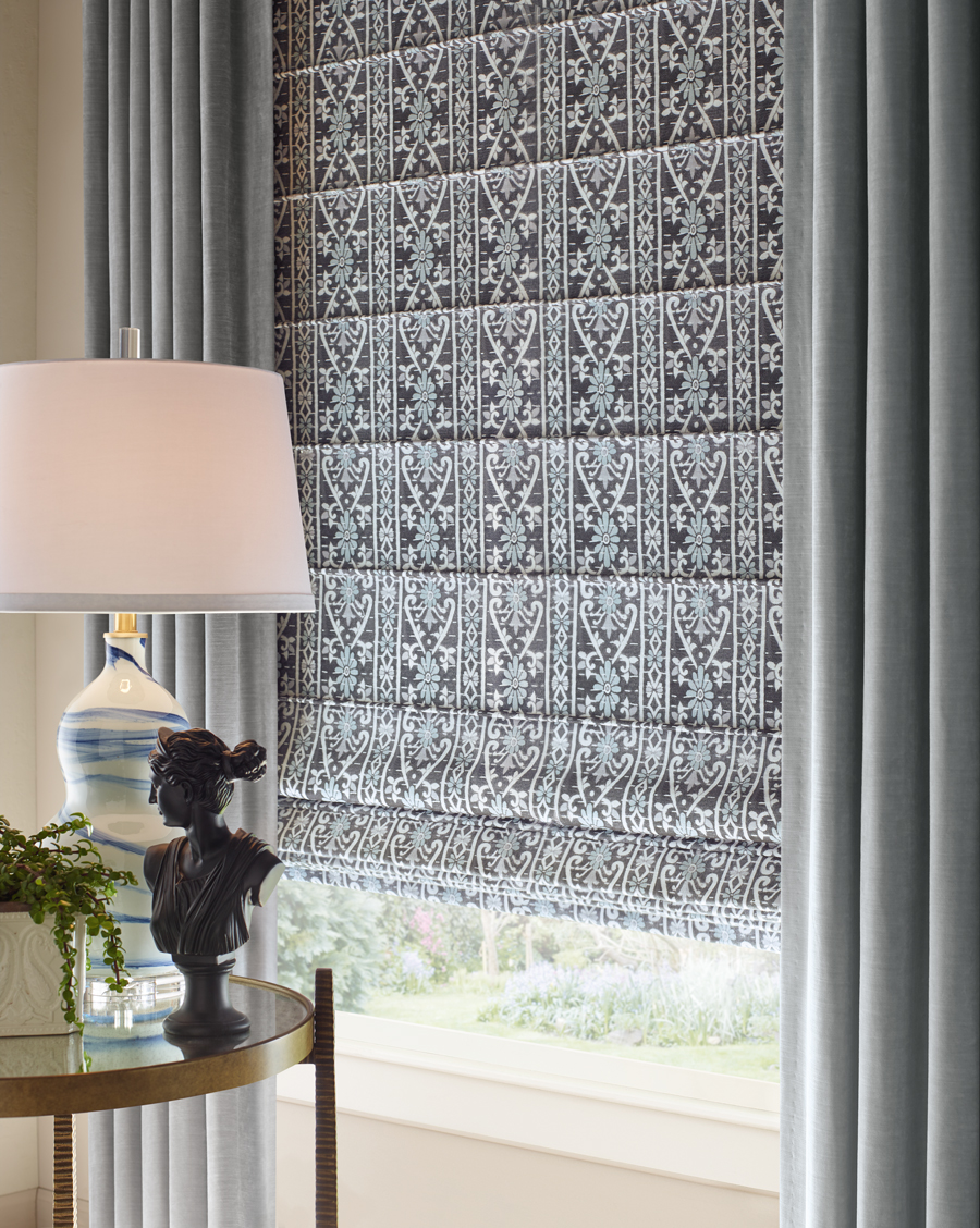 side draperies with roman shades in black and white patterned fabric