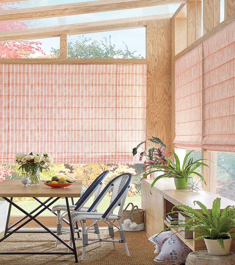outdoor sunroom with pink coral striped window shadings Overland Park, KS