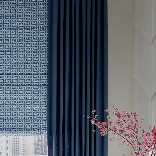 room darkening dark blue drapery and lighter blue pattern shades in home office