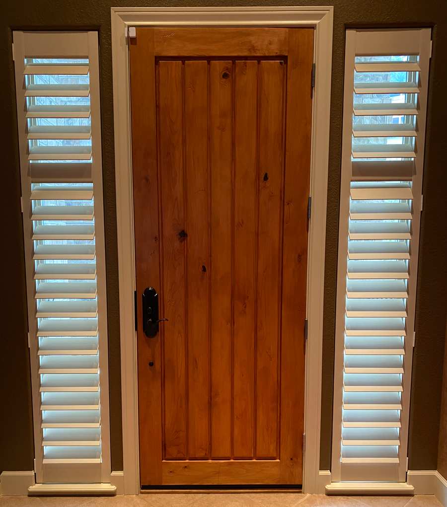 white shutters on sidelights of entryway 