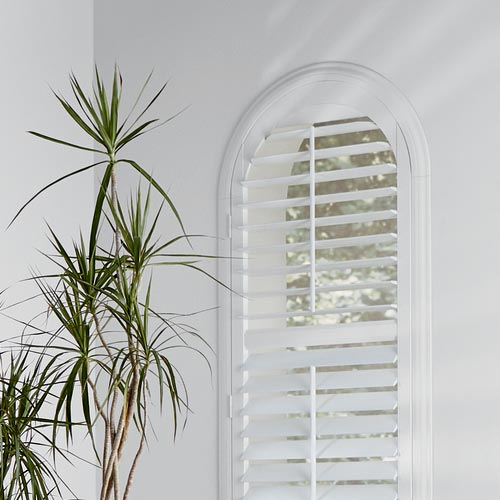 arched windows covered with custom shutters