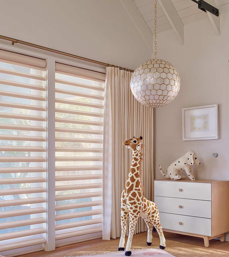 pastel baby nursery floor to ceiling drapery and hunter douglas window shades