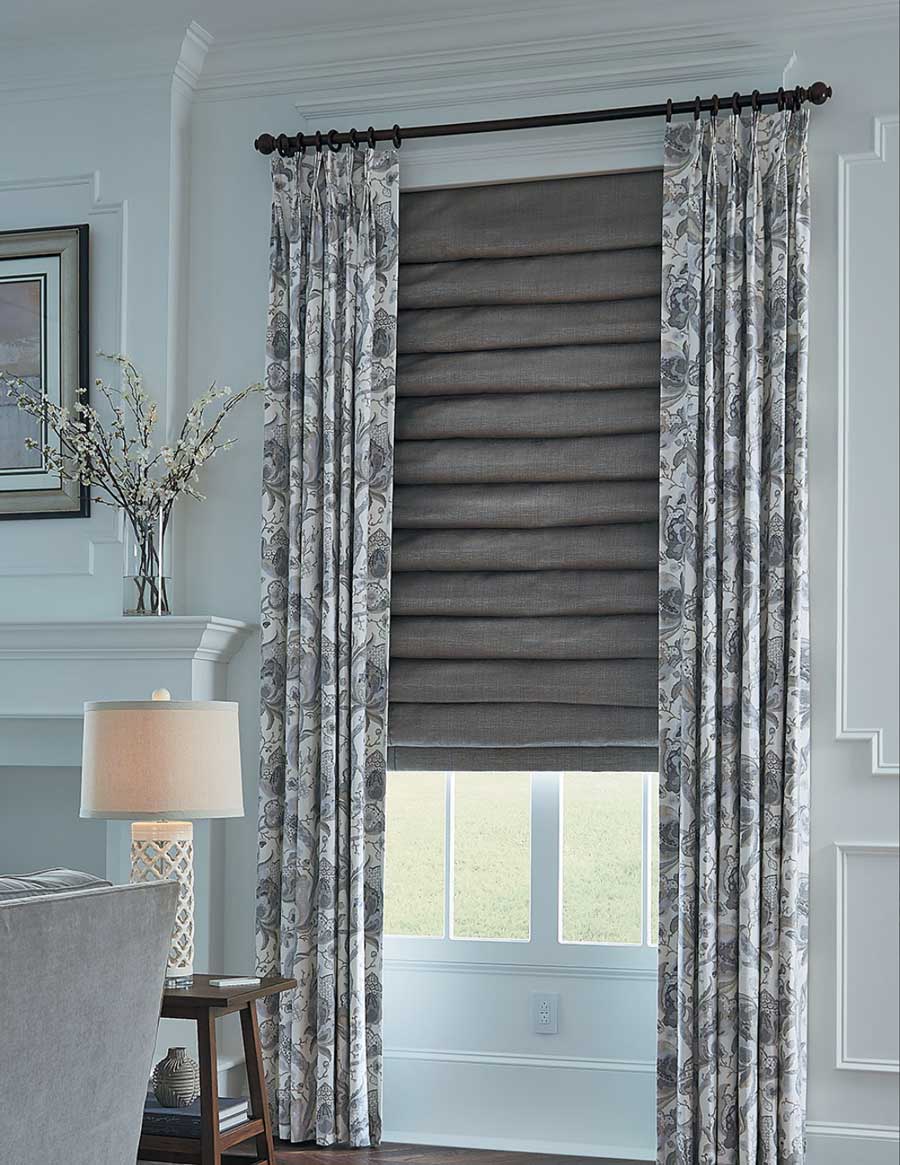 drapery with roman shades as layered fabrics at the window in Overland Park KS