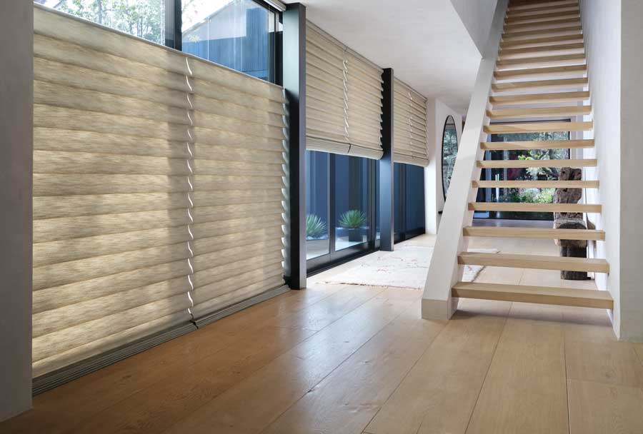 Vignette® Modern Roman Shades in a big open area with a modern staircase