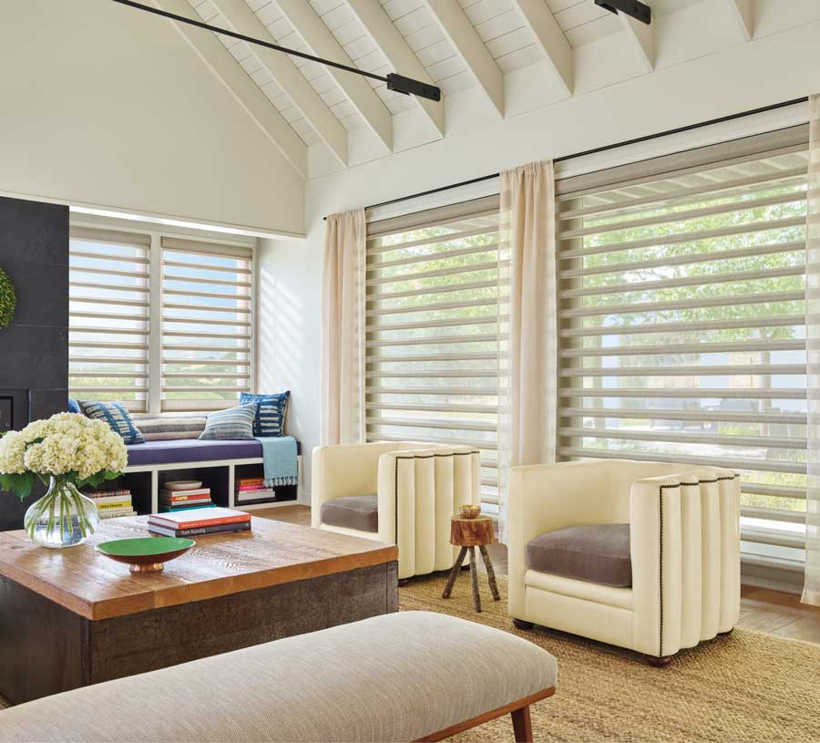 living room with three large wide windows covered with pirouette sheer shades